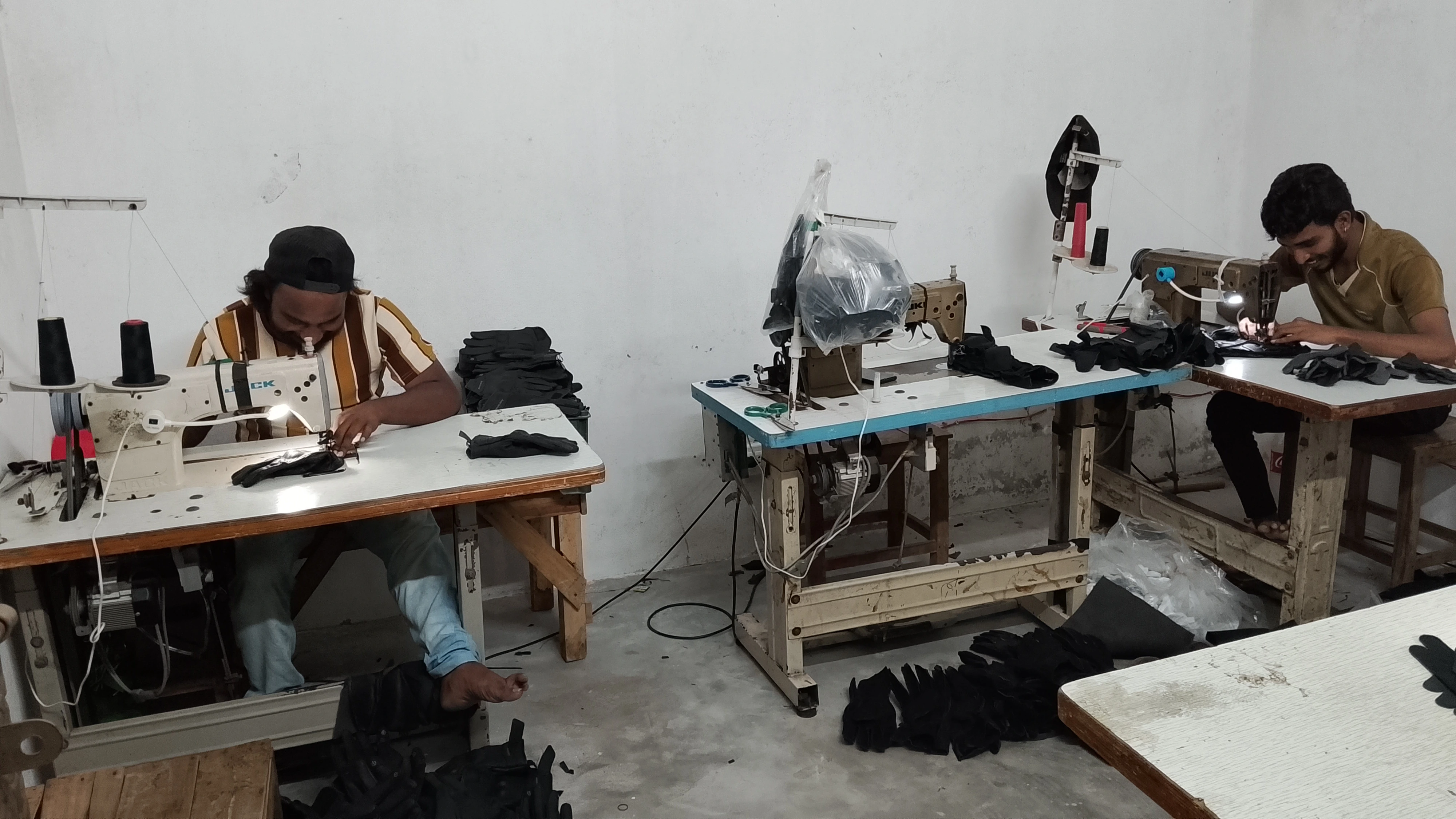 Workers stitching on industrial sewing machines